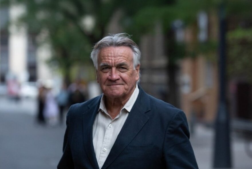 Veteran journalist Barrie Cassidy smiling in a street setting. 