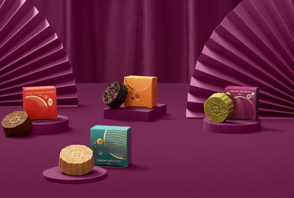 A selection of different flavoured moon cakes in colourful packaging.