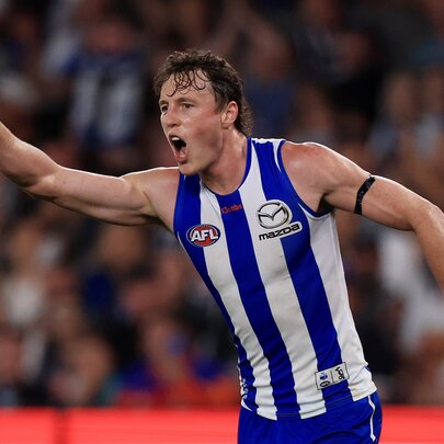 North Melbourne AFL football player gesticulating during a match.