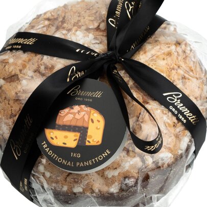 A panettone wrapped in cellophane with a black ribbon. 