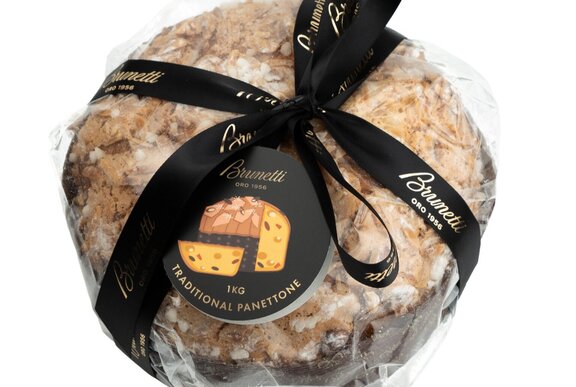 A panettone wrapped in cellophane with a black ribbon. 