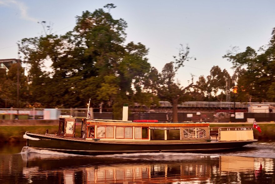 Boats on the Yarra River, with trees in the background.
