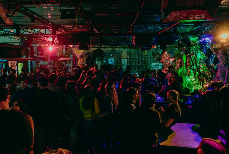 Darkly lit drinking and dancing venue.