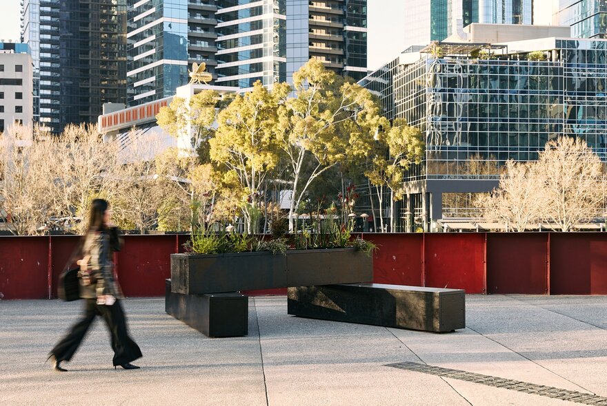 A public art installation in Melbourne with long planter pots and plants. 