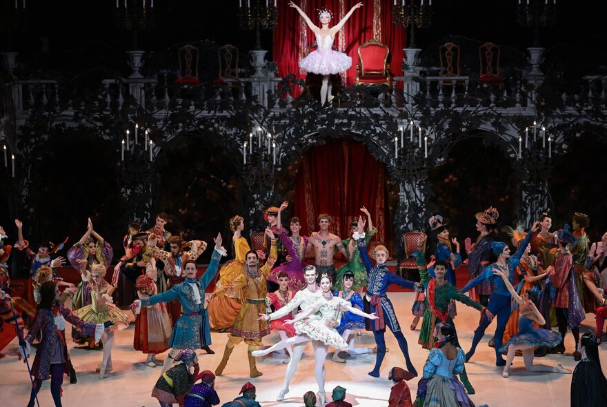 Ballet dancers performing in a crowded scene. 