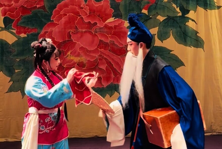 Traditional Taiwanese performers on stage in costume.