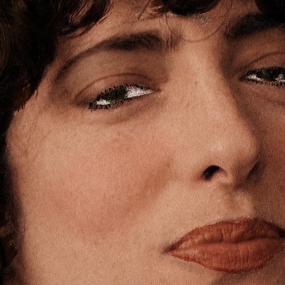 Close-up of woman's face with pursed lips.