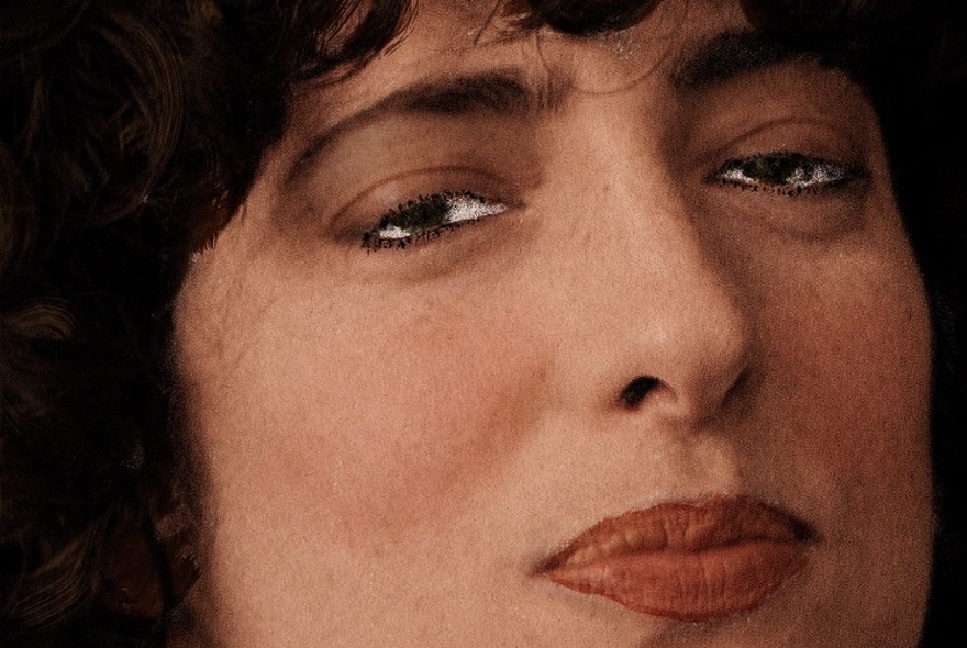 Close-up of woman's face with pursed lips.