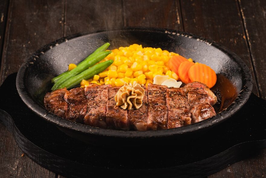 Bowl of cooked sliced meat with sweetcorn, beans and carrots.