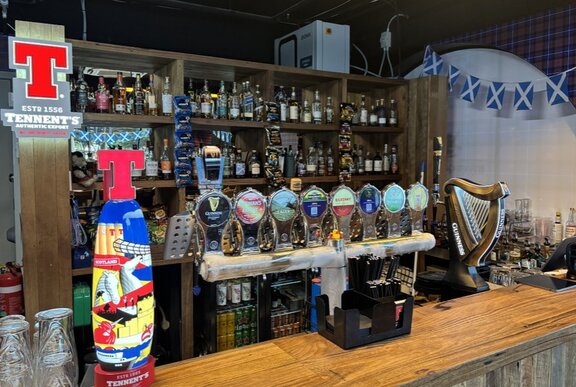 A beer tap at a bar.