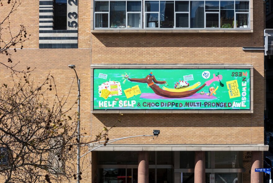 Brightly coloured artwork on the cream brick facade of the Hero apartment building.