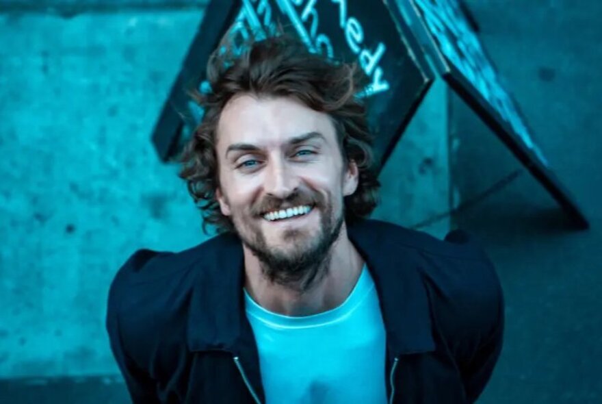 Joseph Green looking up and smiling broadly.