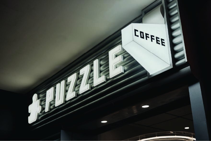 The Puzzle Coffee signage at Melbourne Central.