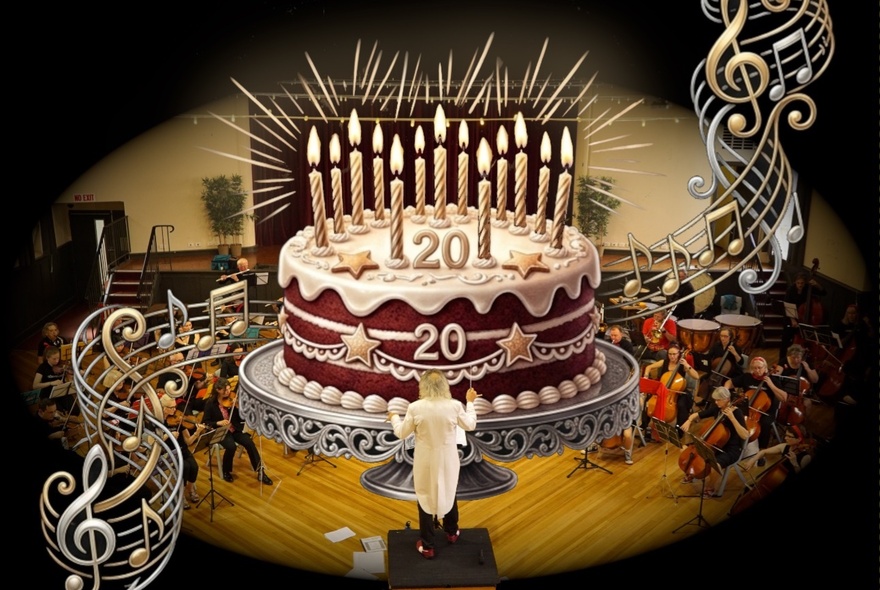 Conductor conducting a large cake with 20 candles, orchestra seated behind the cake.