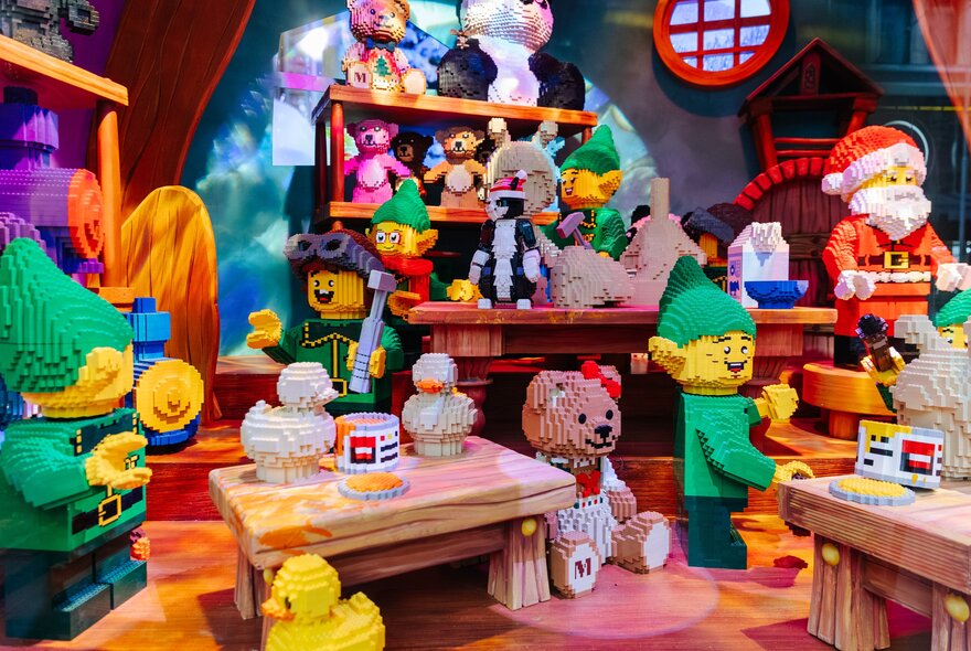 A Christmas toy workshop scene with Santa, elves and lots of toys, all made from LEGO.