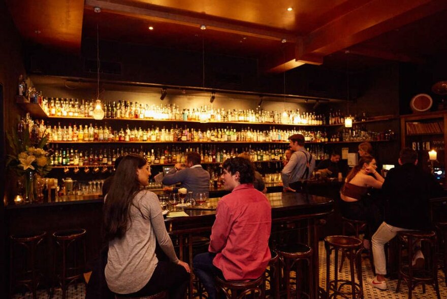 A man and a woman sitting at a bar