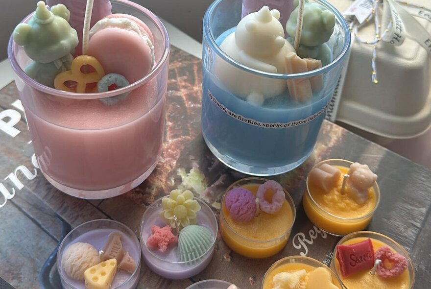 Candy-themed candles in pastel colours with ornamental decorations.