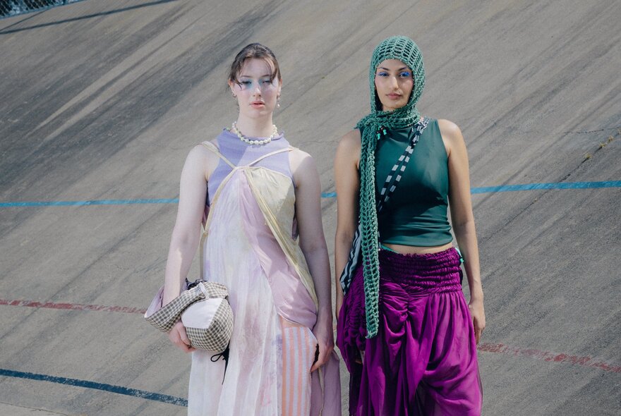 Models wearing loosely draped dress and skirt ensembles.