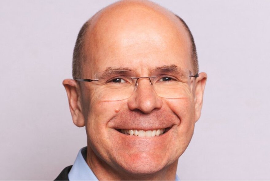 Portrait of Professor George Williams AO, smiling directly at the camera.