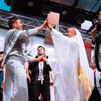 Palestinian performers on stage at Fed Square in traditional clothing.