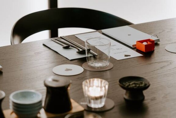 Chair and dining setting with condiments and cutlery.