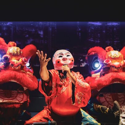 Lunar New Year performers in a mask and lion costume.