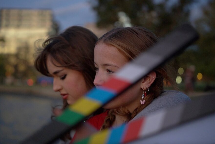 Film still of two young girls in blurred action.