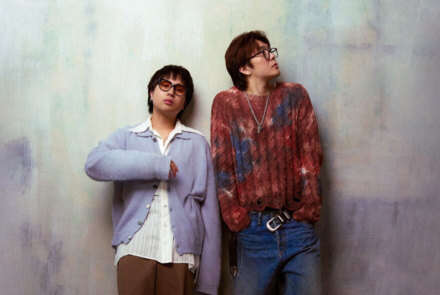 Korean band PRYVT, two young men, one looking to the side, both wearing spectacles.