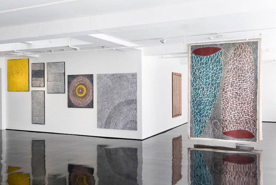 Installation view of an exhibition of paintings in a gallery.