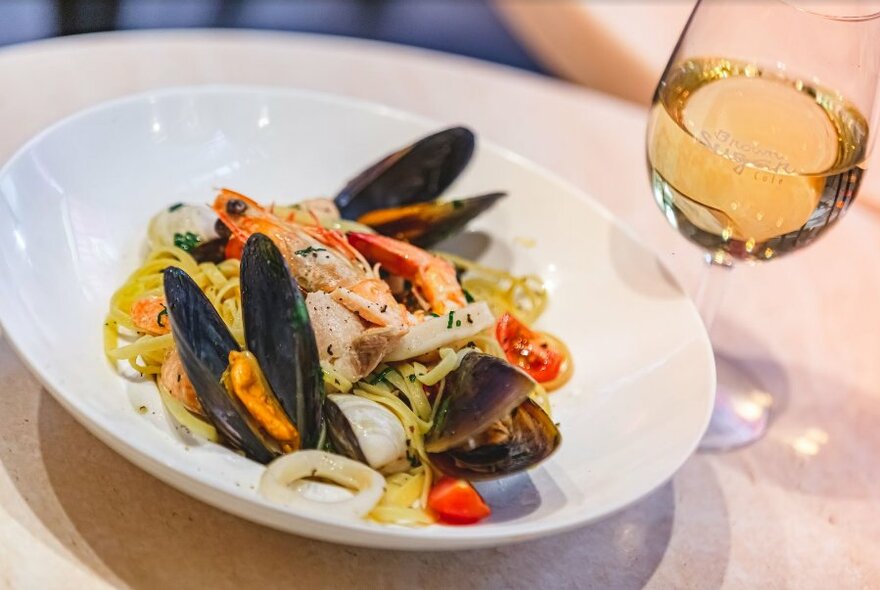 Fettuccine Marinara and a glass of white wine.