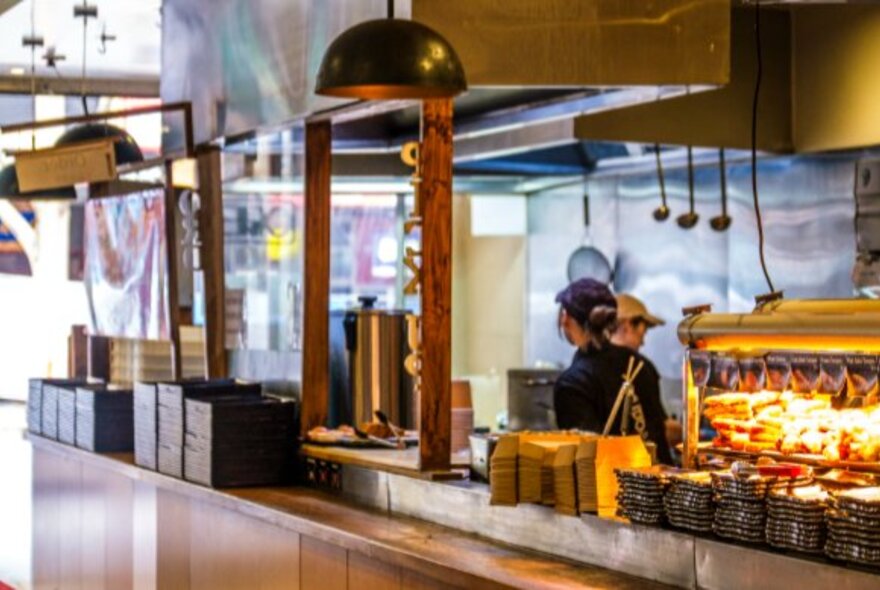 Open kitchen with overhead lights and roasting area.