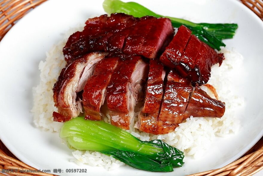 Sliced roast duck served on a bed of white rice with bok choy on the side.