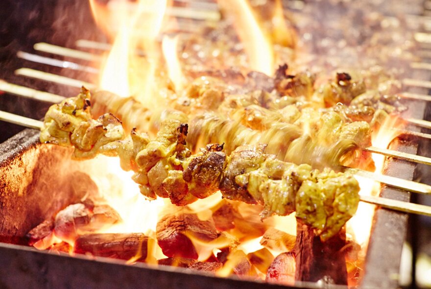 Flaming skewers on a grill