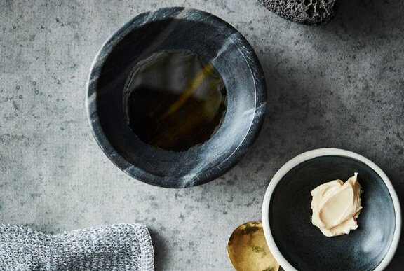 Spa treatment items including bowls, spoon and cream.