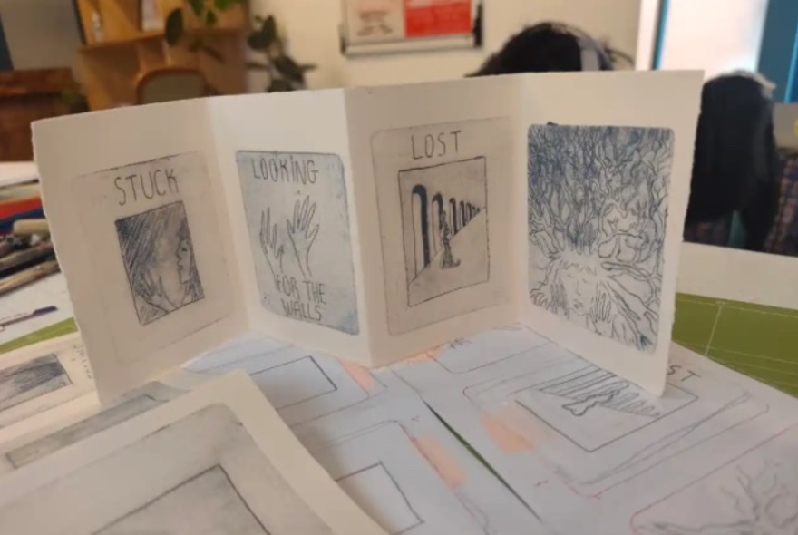 Folded zine on display with printed images.