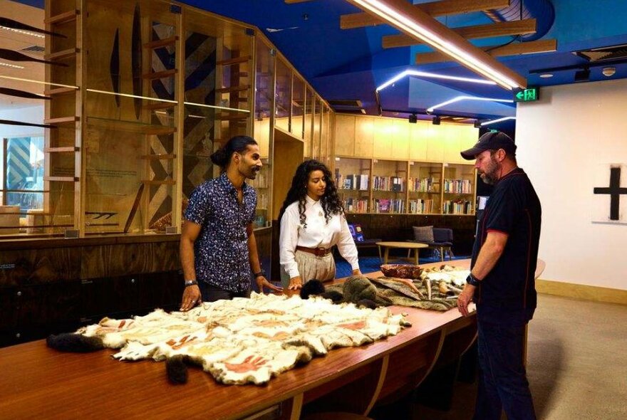 A couple with a tour guide in a museum