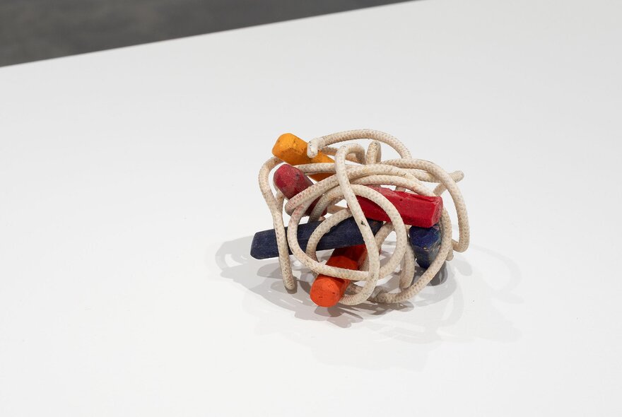 A small abstract sculpture on display in a gallery setting.