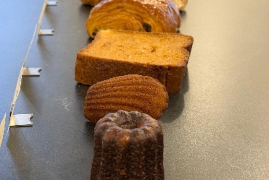 A row of small cakes and pastries. 