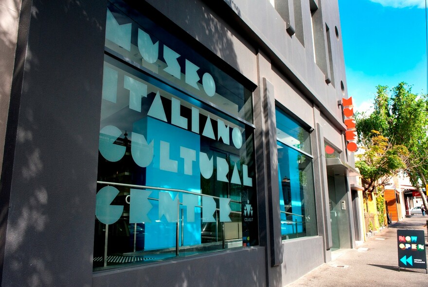 Signage covering front window of Museo Italiano Cultural Centre building.