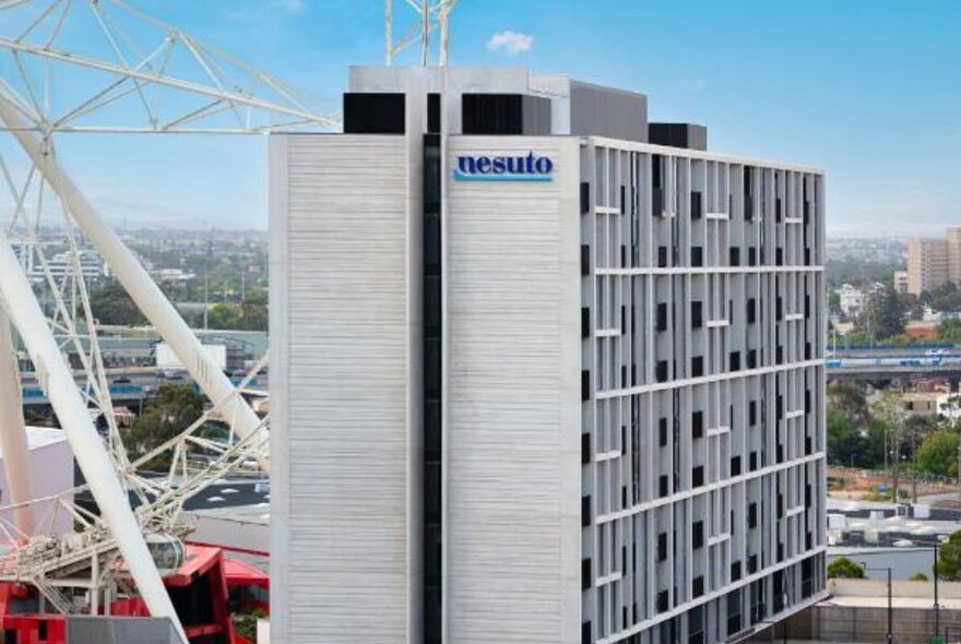 The tall grey Nesuto Apartments building in Docklands.