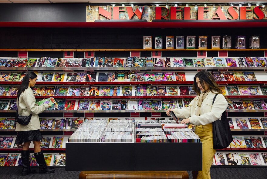 Two women browsing in a comic book store.