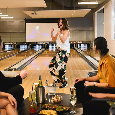 A group of people enjoying themselves at a Kingpin bowling venue, in Crown Melbourne.