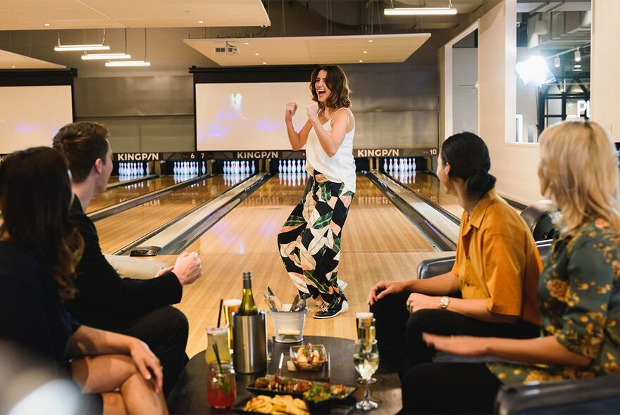 A group of people enjoying themselves at a Kingpin bowling venue, in Crown Melbourne.