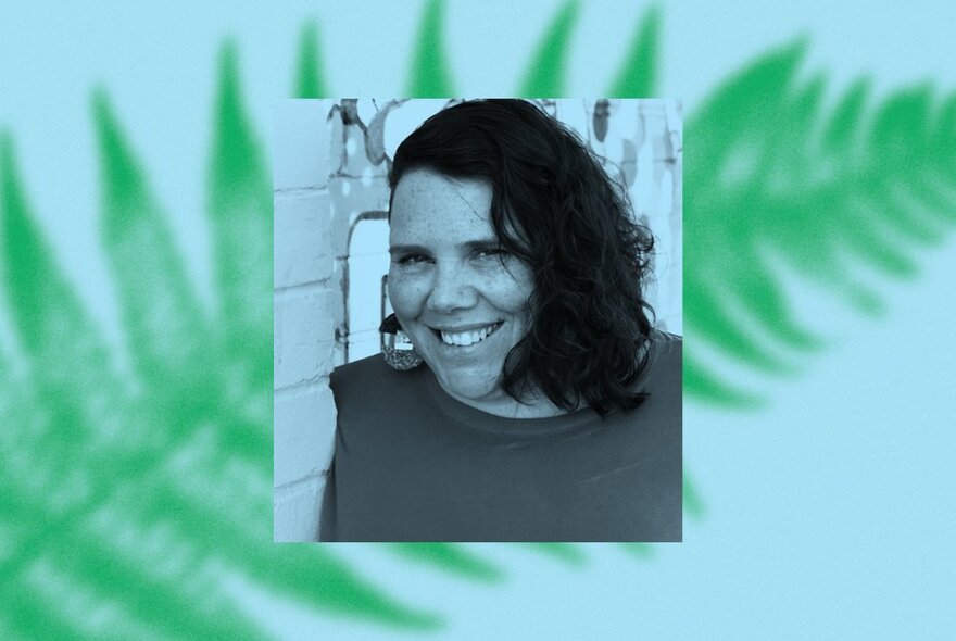 Picture of a woman centred on a fern backdrop.