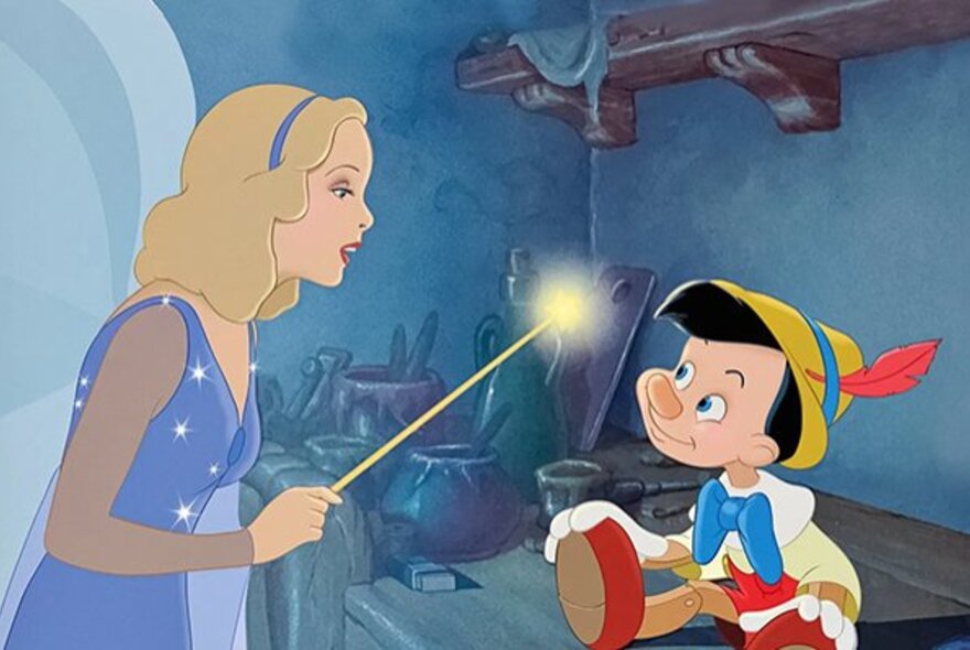 A still image from the Disney film Pinocchio showing a fairy godmother with an illuminated want about to touch Pinocchio.