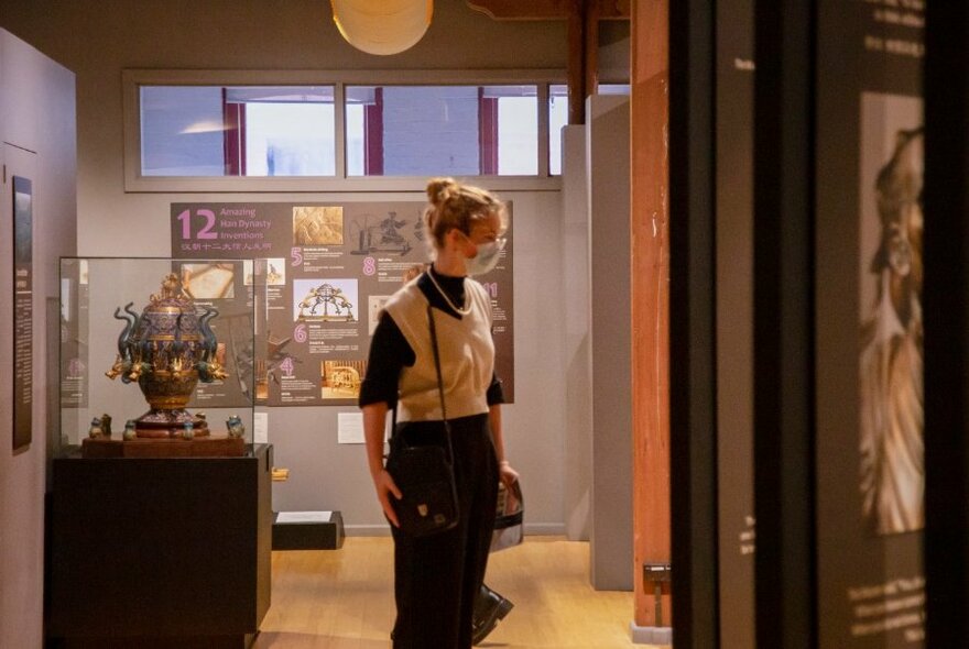 A person looking at a museum display. 