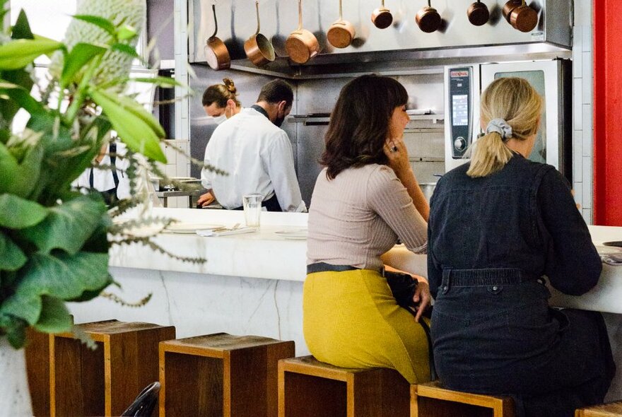 Two people seated in a restaurant.