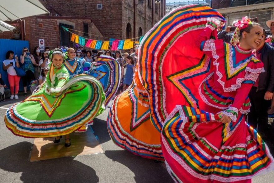 Spanish flamenco dancers swirling the skirts of their brightly coloured dresses.
