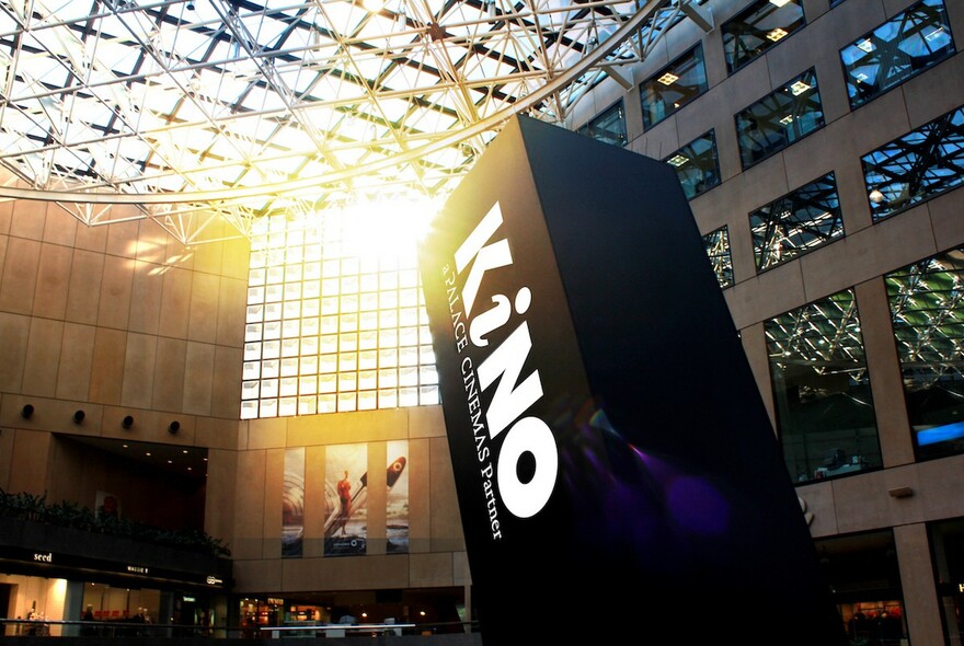 Large Kino Cinema sign in Collins Place atrium.