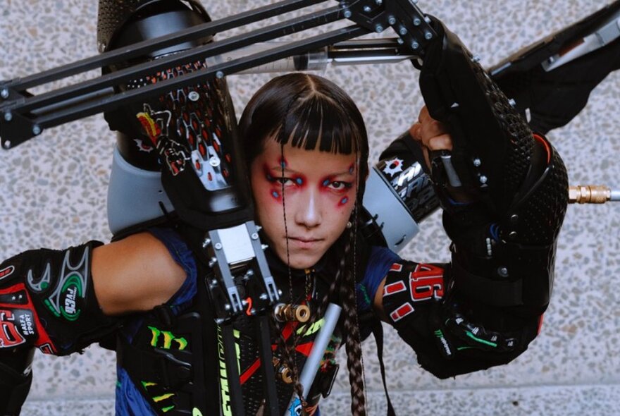 A performer wearing a chunky and robotic cyborg-like costume.